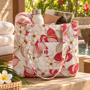 Anthurium Bloom cotton tote bag in cream color with front pocket in a poolside setting