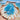 Scallop shell trinket dish with hand-poured blue resin ocean design and ocean in the backgroun