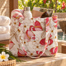 Anthurium Bloom cotton tote bag in cream color with front pocket in a poolside setting