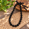 Genuine kukui nut lei with adjustable ribbon tie in black
