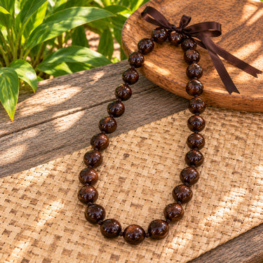 Genuine kukui nut lei with adjustable ribbon tie in brown